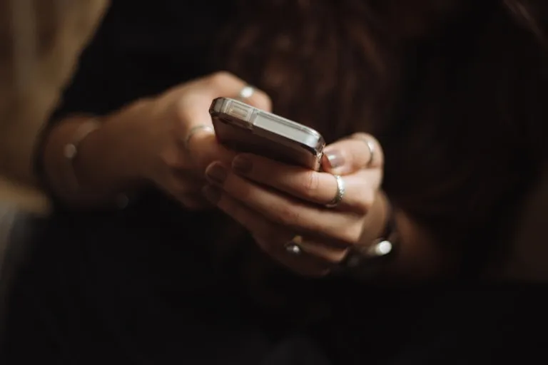 A pair of hands holding a phone, mid-search