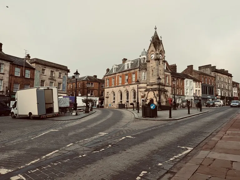 Penrith town centre with traditional stone buildings and the surrounding Cumbrian landscape